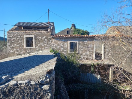 Two connected traditional stone houses with garden in the center of the island